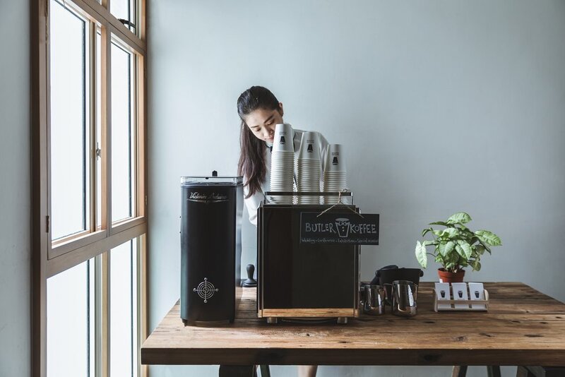 Female barista serving coffee at a coffee cart