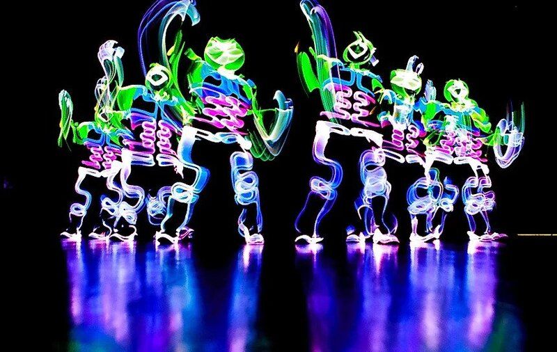 Dancers wearing LED costumes performing at a dinner and dance