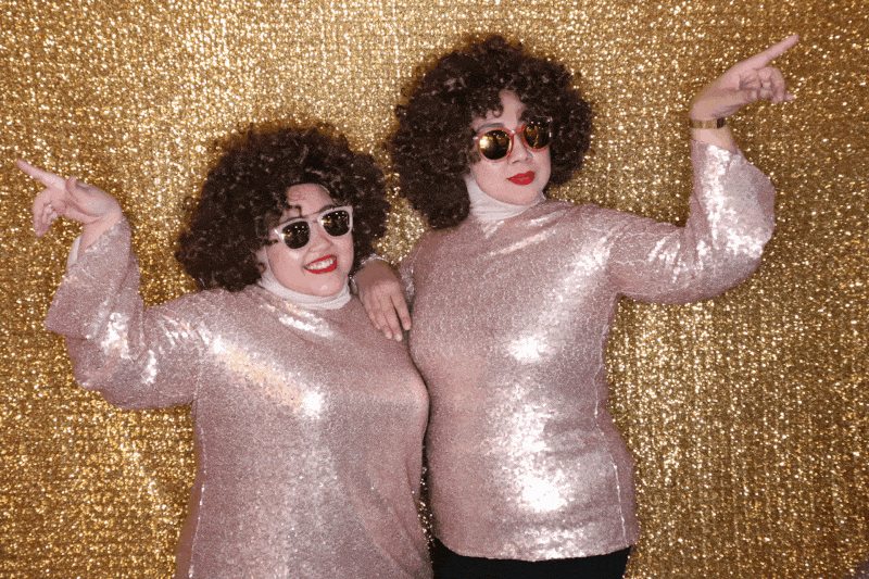 Women dressed up in costumes at a GIF photo booth