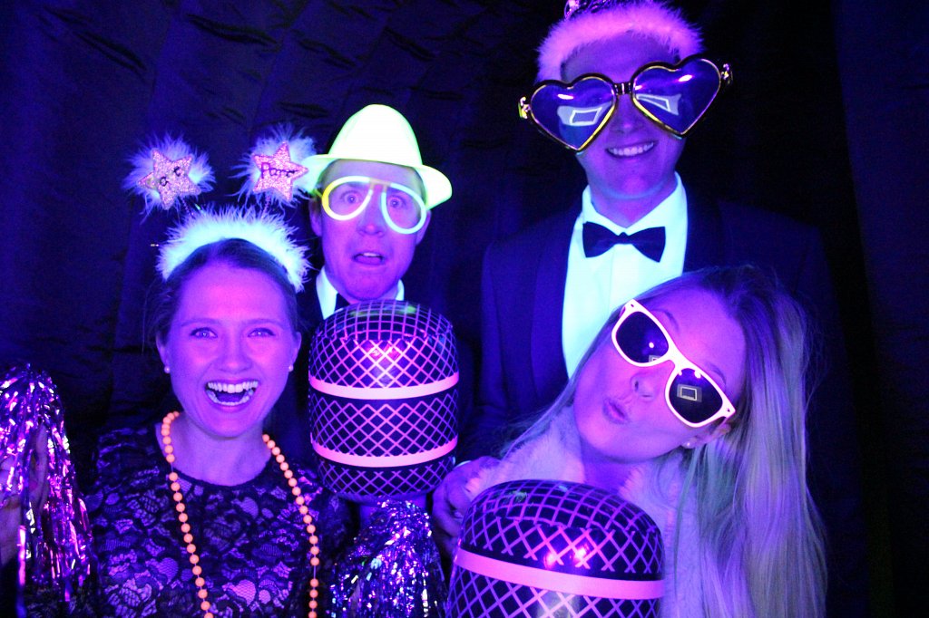 People posing with neon lights and reflective clothing in neon photobooth uv light photoshoot night dark