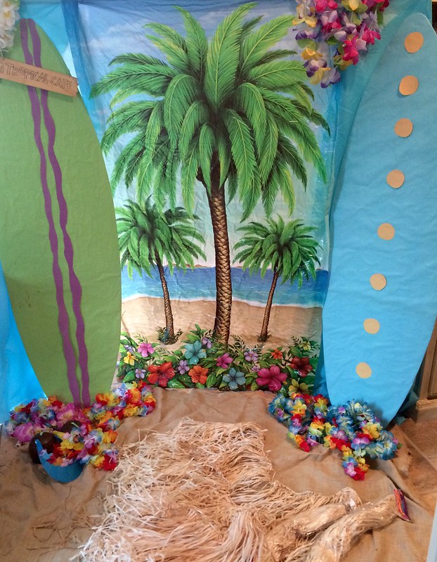 DIY Beach style backdrop with palm trees flowers surfboards for photoshoot tropical photobooth background