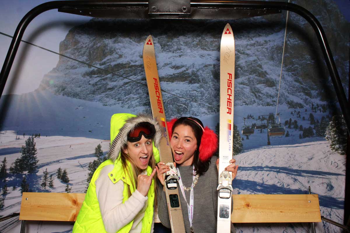 People posing for photo ski lift outfit theme winter sports event photoshoot promotion photobooth